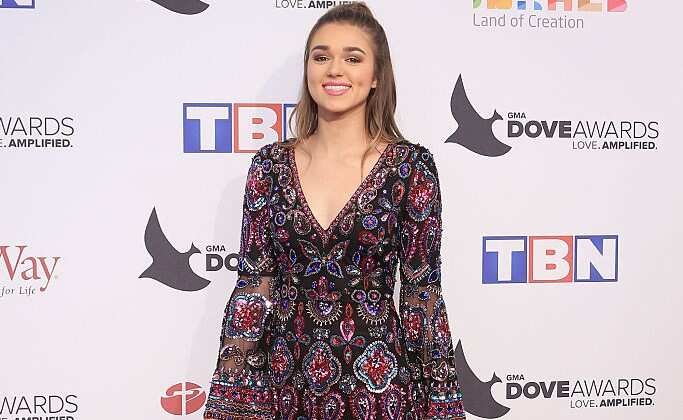 Sadie Robertson poses for a photo in a flowered dress