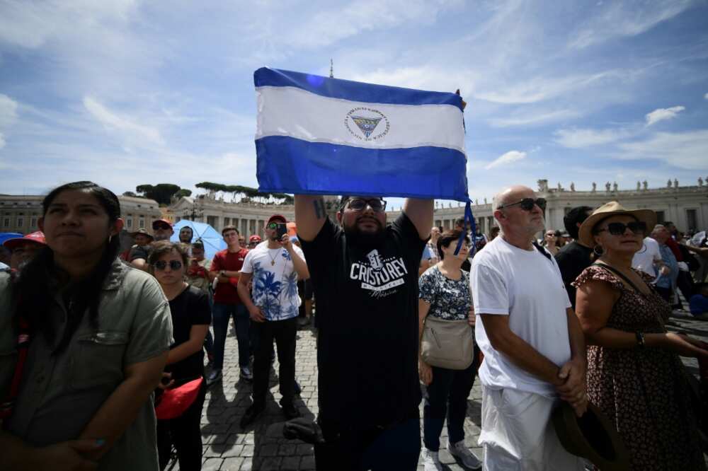 A man holds the national flag of Nicaragua at St. Peter's square during the Pope's weekly Angelus prayer on August 21, 2022 in The Vatican