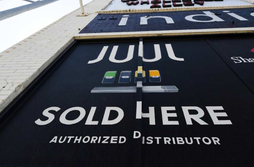 (FILES) In this file photo taken on September 17, 2019 a sign advertises Juul vaping products in Los Angeles, California