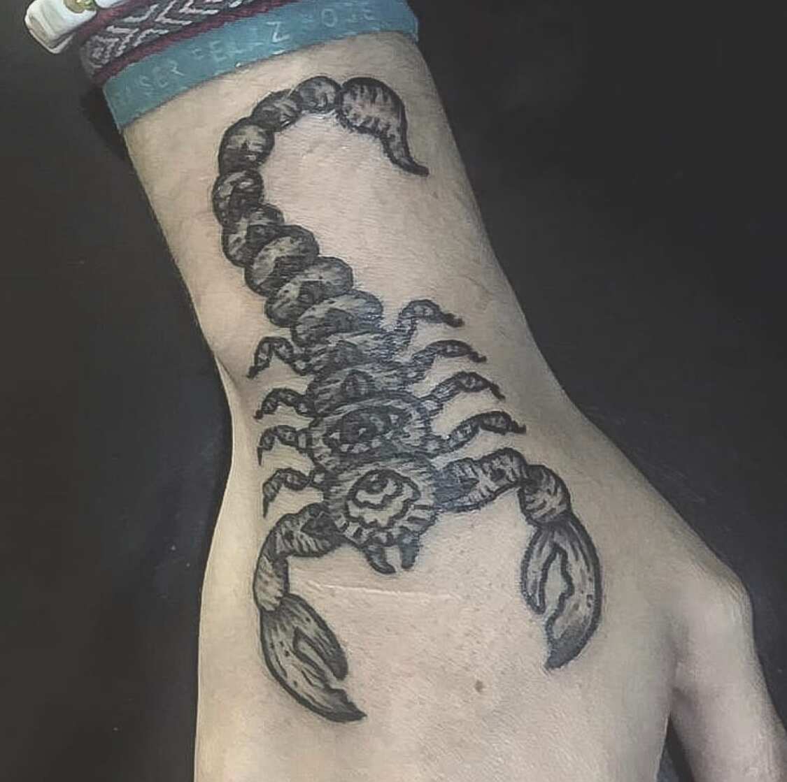 Scorpion tattoo located on the forearm, watercolor