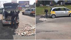 Taxi driver packs stones in his car to fill potholes on road, photos capture attention