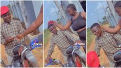 "The guy cute": Nigerian lady professes love to shy okada man, caresses and gives him cash, video stuns many