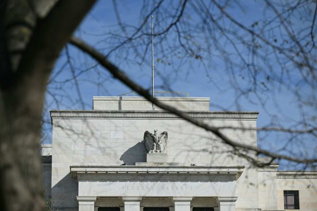 US Fed holds key rate, pencils in 3 cuts this year
