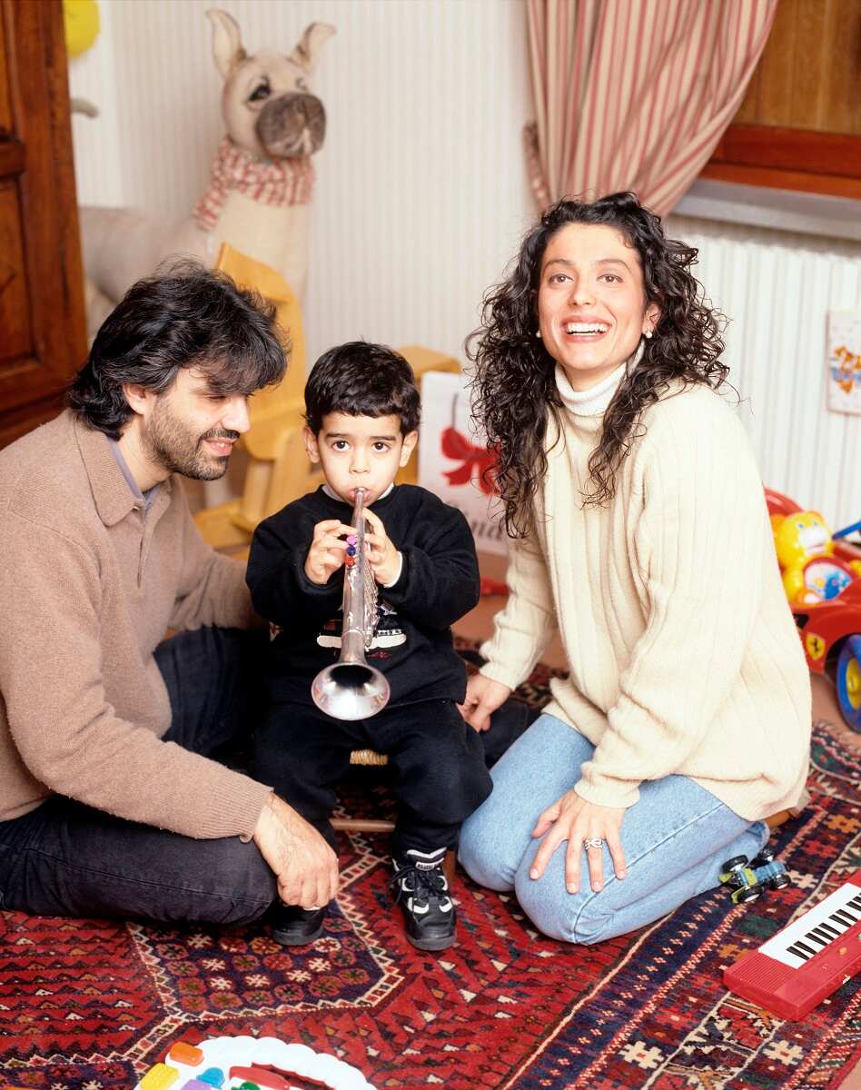 Andrea Bocelli at the piano with his wife Enrica Cenzatti and their son Amos.  The Italian tenor Andrea Bocelli seated at the …