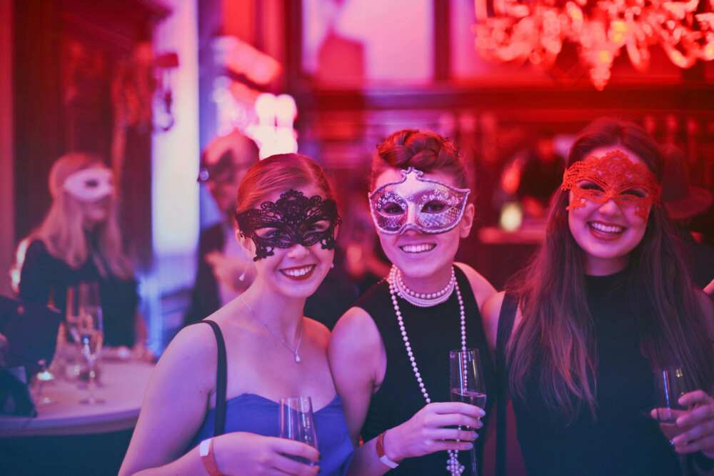 Women wearing masquerade masks at a party held in Budapest, Hungary