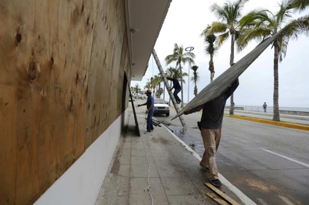 Workers board up windows ahead of Hurricane Orlene's arrival, in Mazatlan, Mexico on October 2, 2022