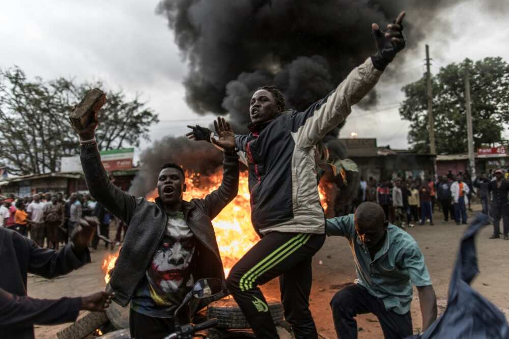 Supporters of Kenya's defeated presidential candidate Raila Odinga set tyres on fire in the Nairobi slum of Kibera