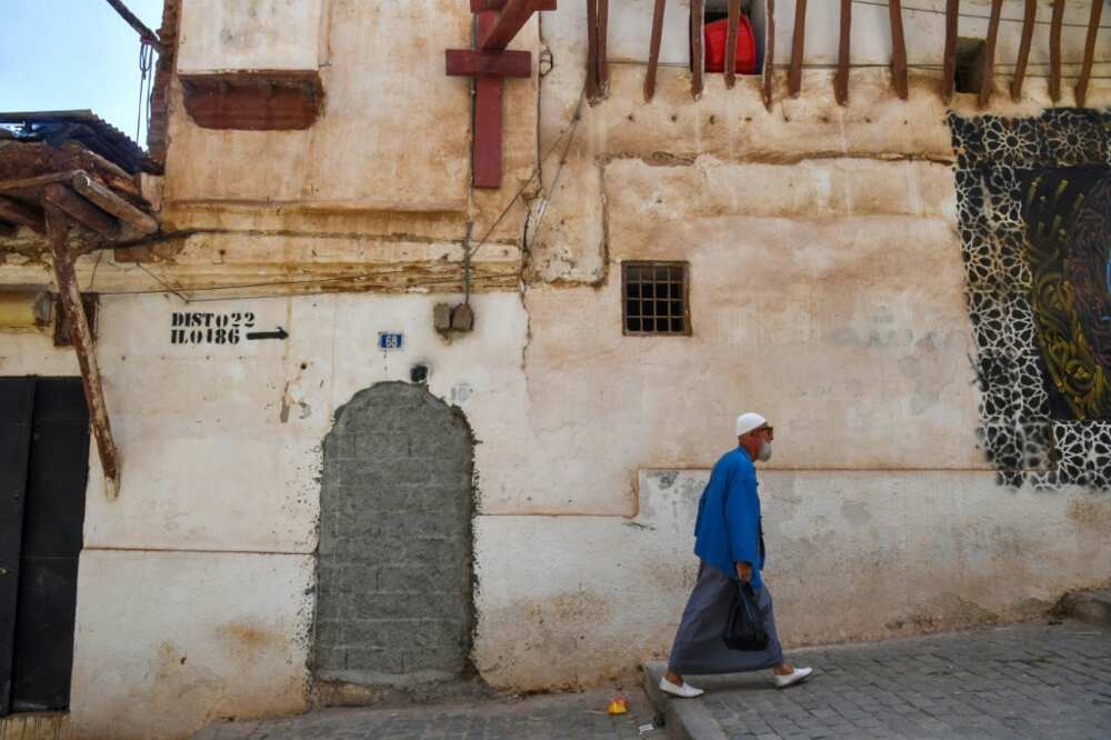 A man walks down a street in the historic Casbah of Algiers