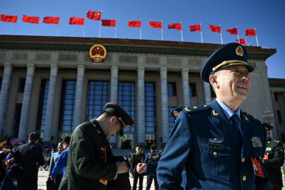 Delegates react after the closing ceremony of the 20th Communist Party Congress at the Great Hall of the People in Beijing
