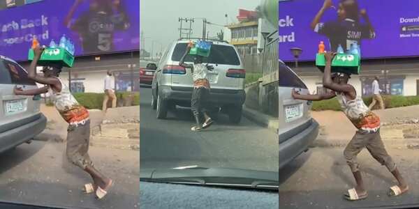 A young Nigerian hawking bottled water was seen helping to pushed a car in Lagos with is goods on his head.