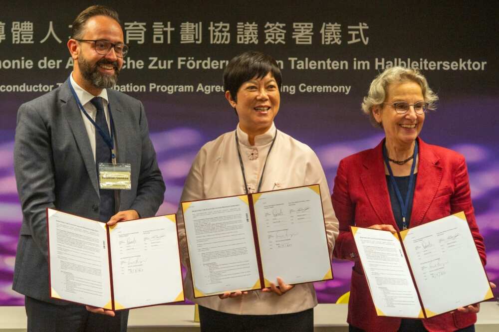 Lora Ho (C), senior vice president of human resources at TSMC, poses with Sebastian Gemkow (L), Saxony state's minister of science, and Ursula Staudinger (R), president of the Dresden University of Technology
