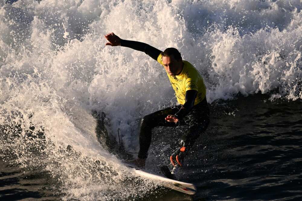 French athlete Eric Dargent, who has a prosthetic foot, surfs in his heat on the second day of competition at the World Para Surfing Championship in Pismo Beach, California, on December 6, 2022 French athlete Eric Dargent, who has a prosthetic foot, surfs in his heat on the second day of competition at the World Para Surfing Championship in Pismo Beach, California, on December 6, 2022