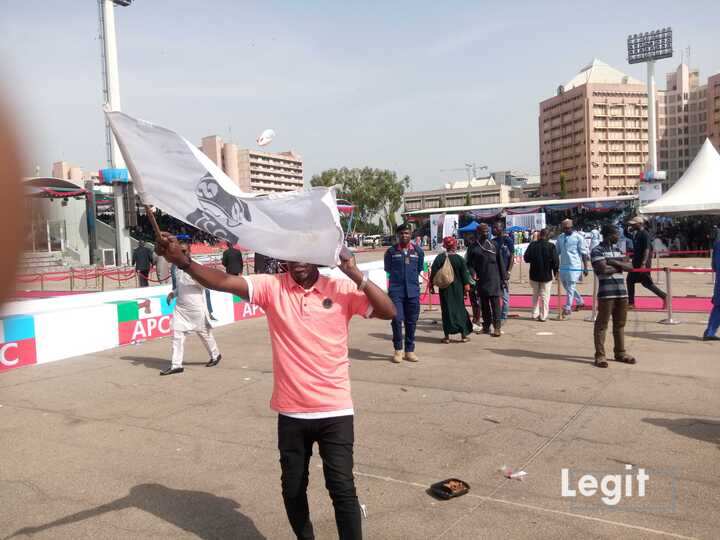 A Pro-Tinubu Supporter Waving a Flag of Bola Tinubu’s Image at the Eagle Square, Abuja.