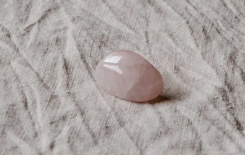 A close-up shot of a rose quartz on a piece of cloth