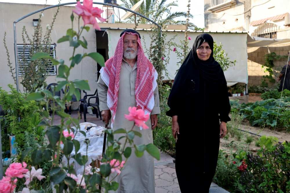 Suleiman and Nazmiya Baraka walk in their garden Suleiman and Nazmiya Baraka walk in their garden