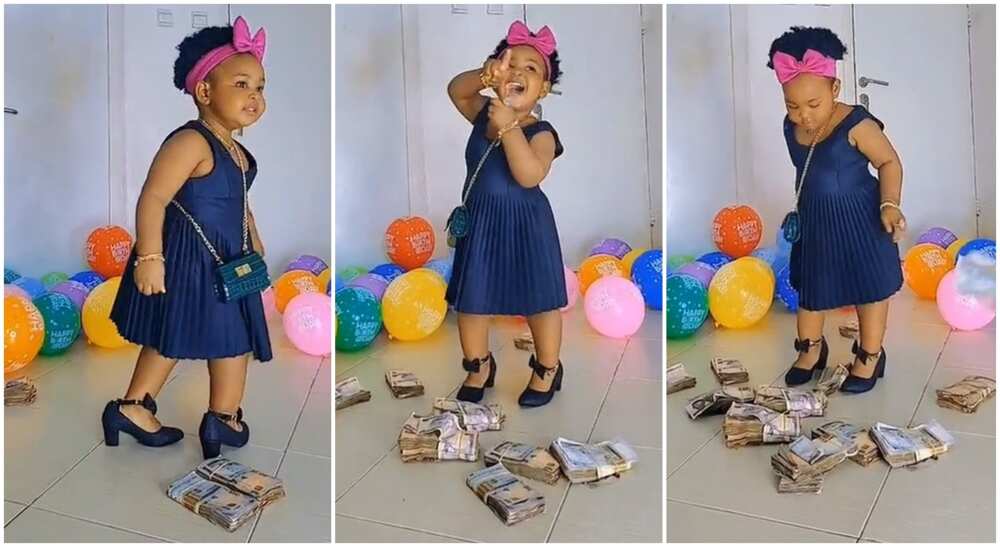 Photos of little Nigerian girl dancing as she is gifted bundles of cash.