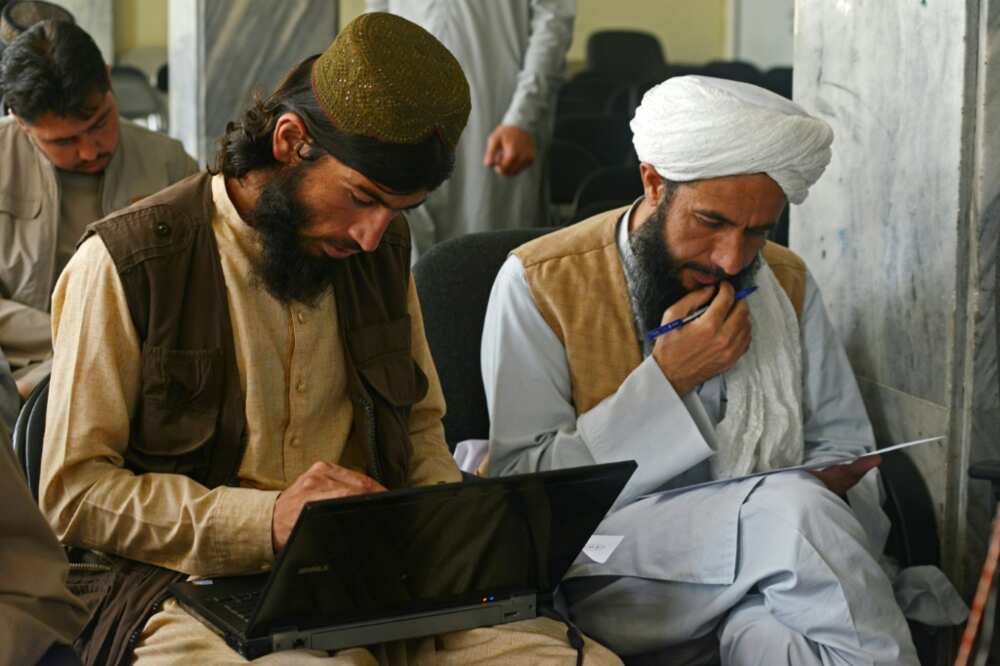 Taliban member Gul Agha Jalali (L) is one of many fighters who have traded combat for the classroom following the group's return to power