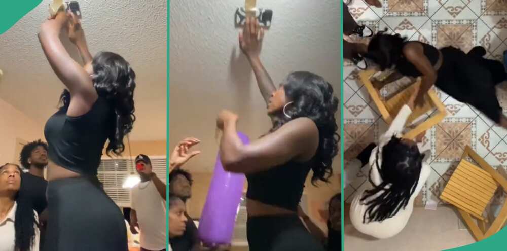 Lady falls while attempting ceiling challenge.