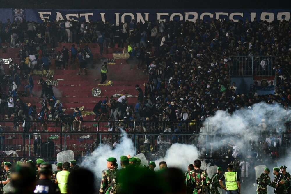 Police fired tear gas into packed stands