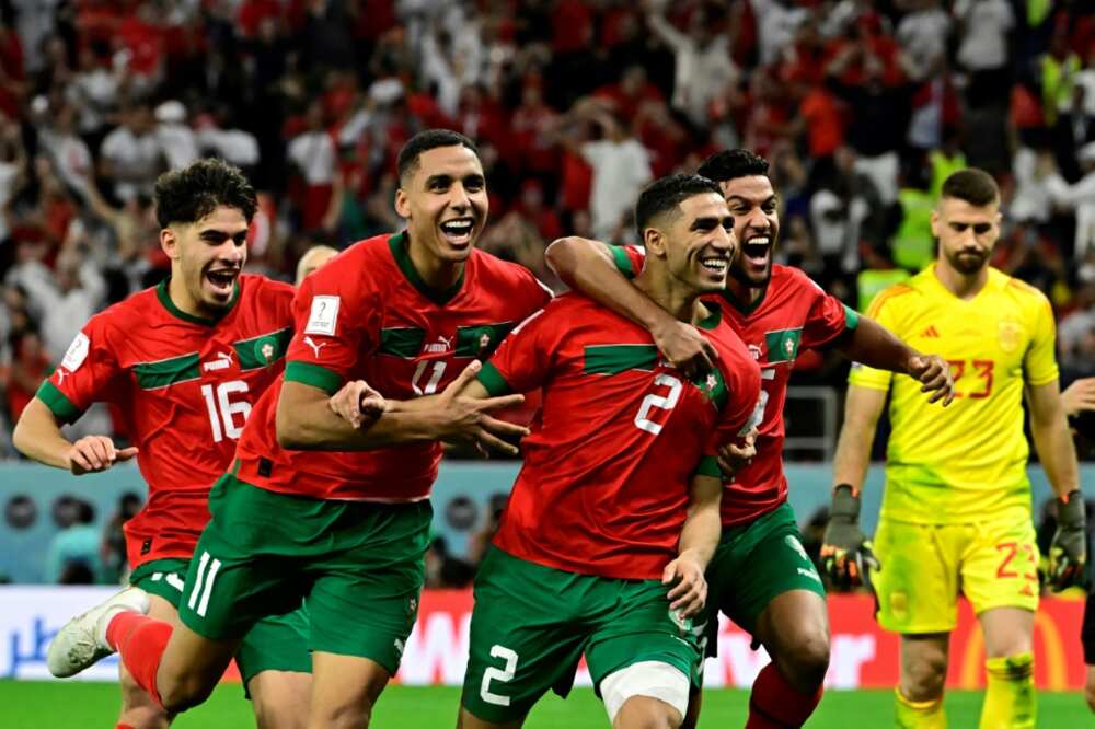 Achraf Hakimi (2nd R) sent Morocco into the World Cup quarter-finals for the first time with a nerveless winning penalty