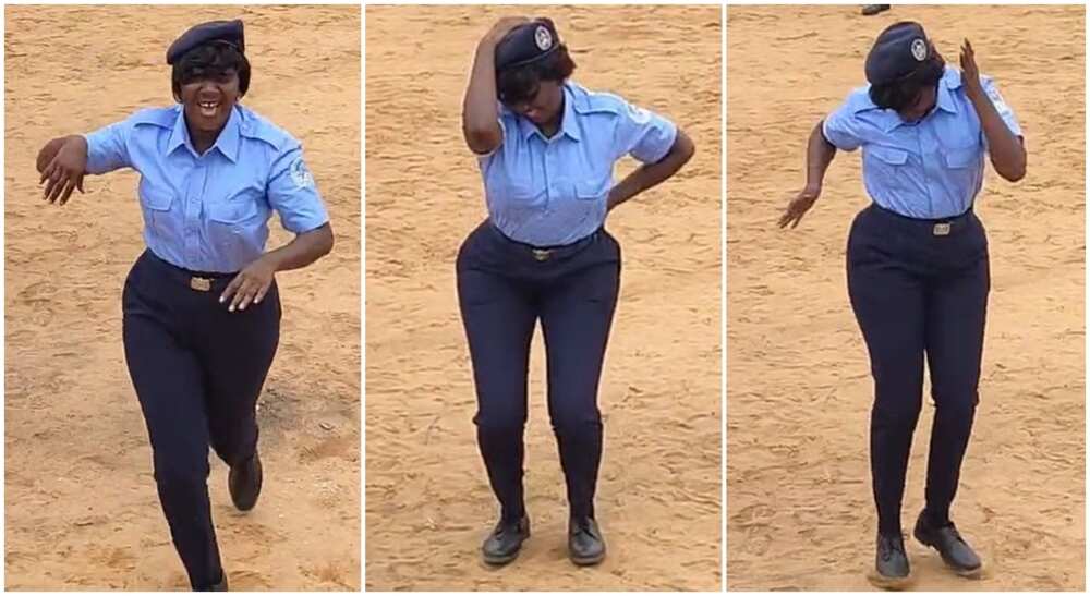 Lady in security uniform dancing in open arena.