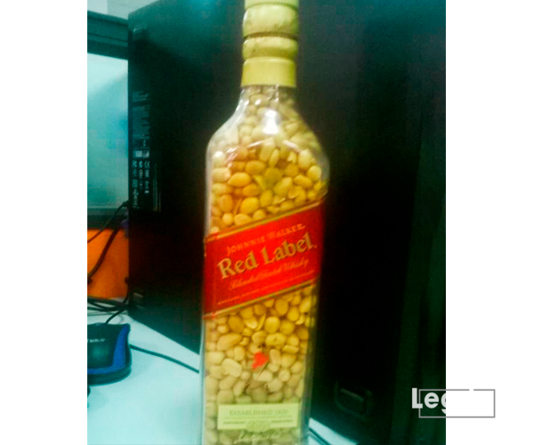 Groundnuts in a Red Label Bottle