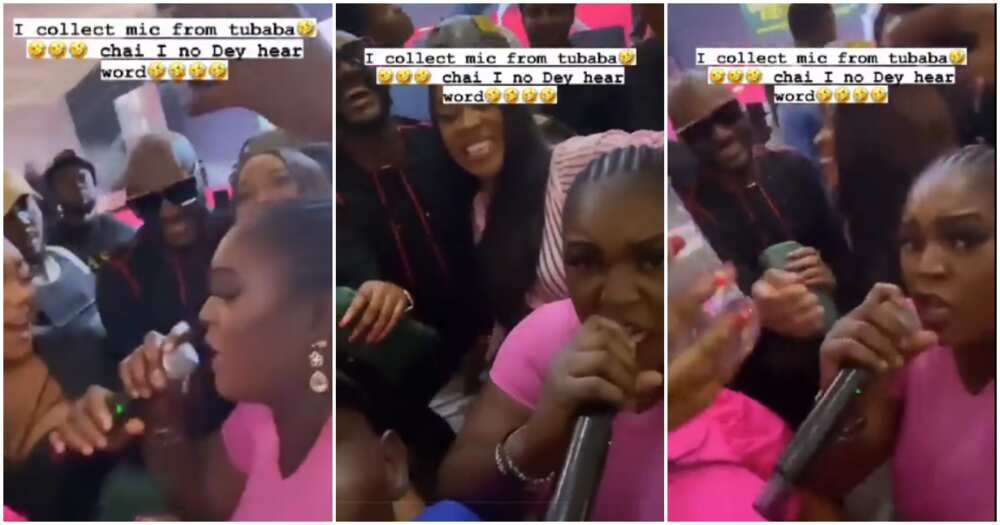 Woman collects microphone from 2baba during his performance.