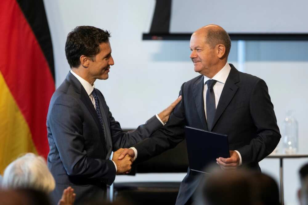 Canada's Prime Minister Justin Trudeau (L) shakes hands with German Chancellor Olaf Scholz in Toronto, where the leaders agreed to a hydrogen trade deal that could see Europe lessen its reliance on Russian energy supplies