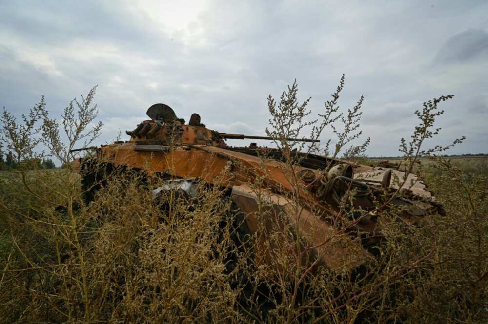 A Russian tank lies on the village's outskirts