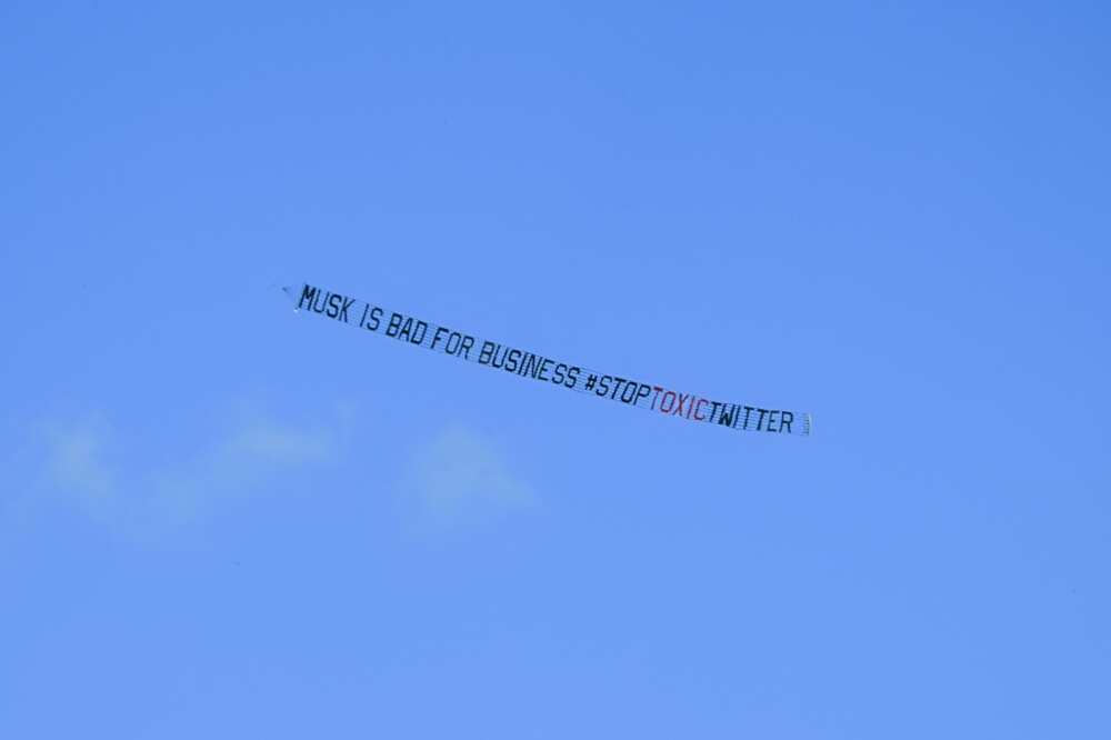 A banner reading, "Musk is Bad for Business #StopToxicTwitter" is flown over a conference venue in Miami, Florida where the Twitter CEO made a keynote address