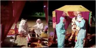Couple marries in full protective gear at isolation center after bride tests positive for COVID-19 Couple marries in full protective gear at isolation center after bride tests positive for COVID-19