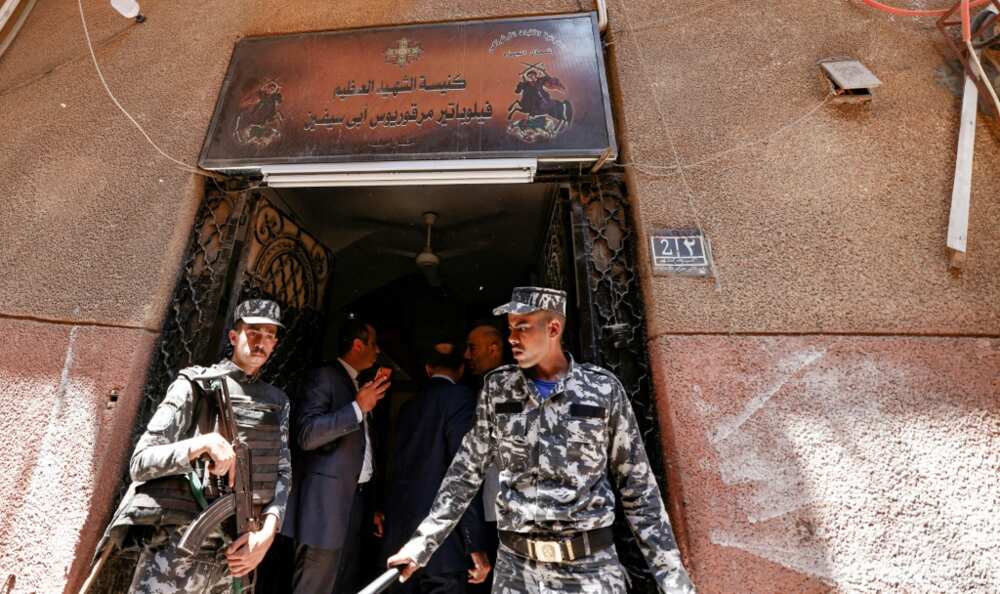 Egyptian police outside the charred Abu Sifin church located in the densely populated Imbaba neighbourhood west of the Nile river on August 14, 2022 Egyptian police outside the charred Abu Sifin church located in the densely populated Imbaba neighbourhood west of the Nile river on August 14, 2022