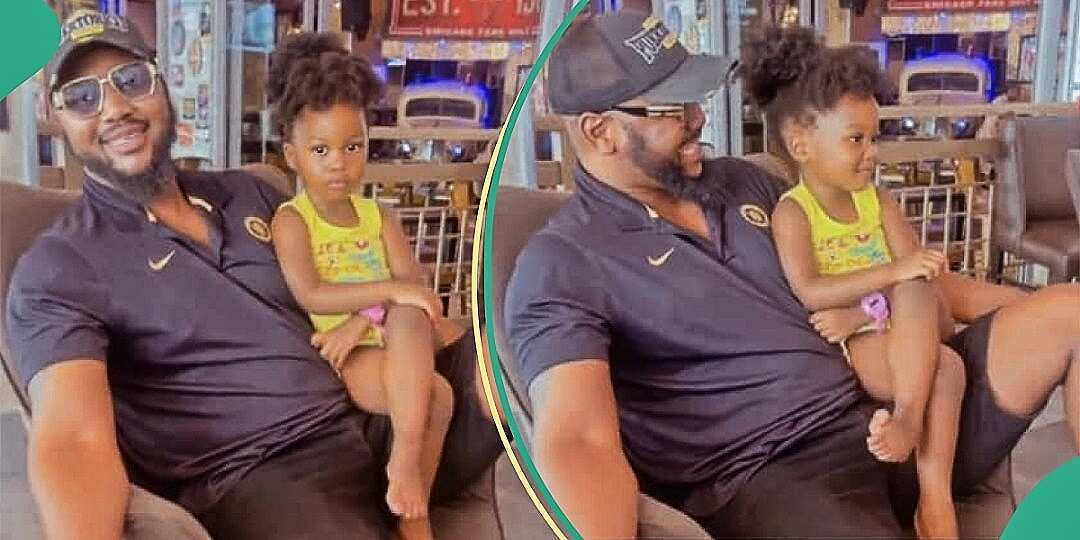 Watch funny video of little girl crossing her legs while sitting on dad's lap