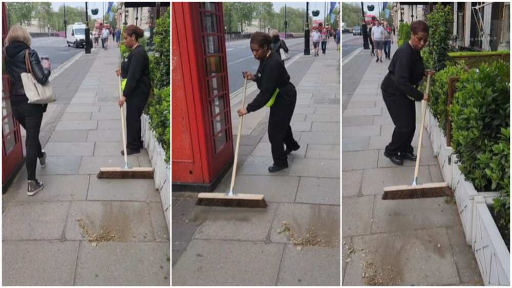 Working in UK/Woman sweeps the street.