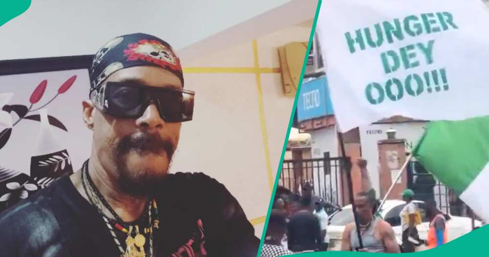 Hank Anuku takes to streets to protest hunger with 'Hunger Dey O' flag.