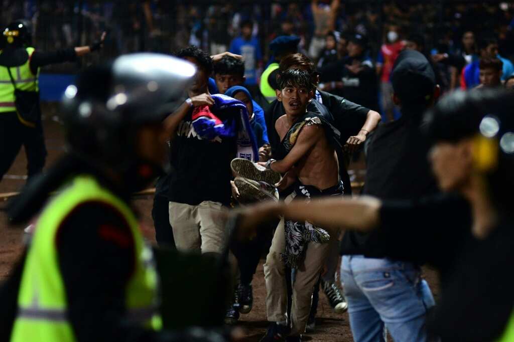 Chaos before stampede delivered disaster to Indonesia football fans