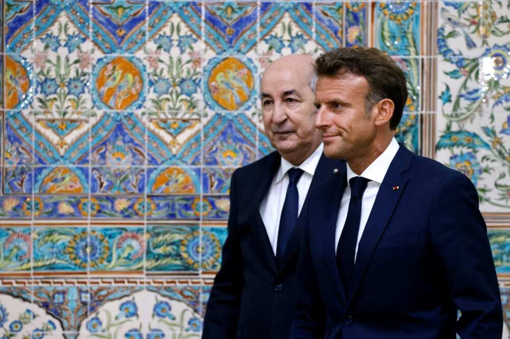 French President Emmanuel Macron (R) and Algeria's President Abdelmadjid Tebboune (L) leave at the end of a joint press conference at the presidential palace in Algiers on August 25, 2022