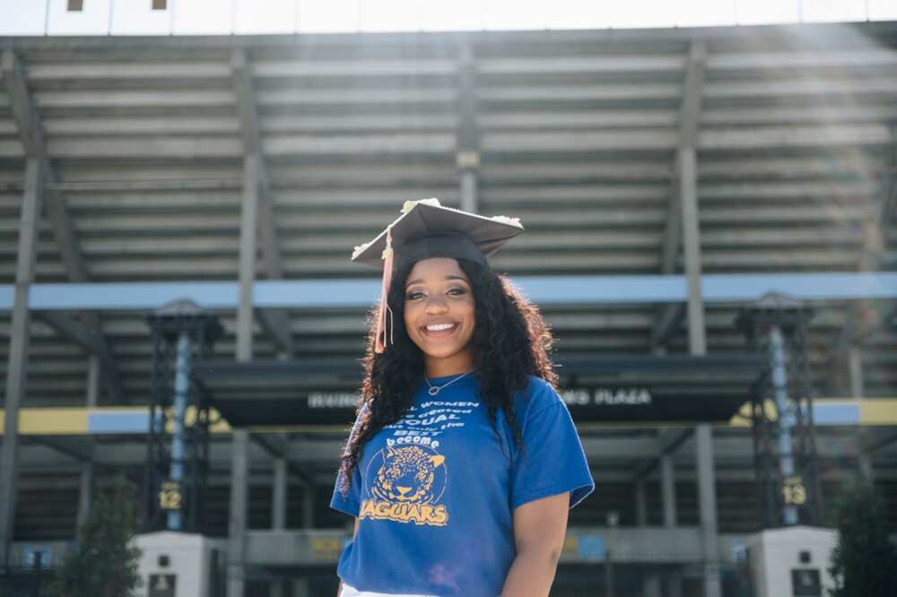 Young lady wearing a blue shirt with a graduation gown