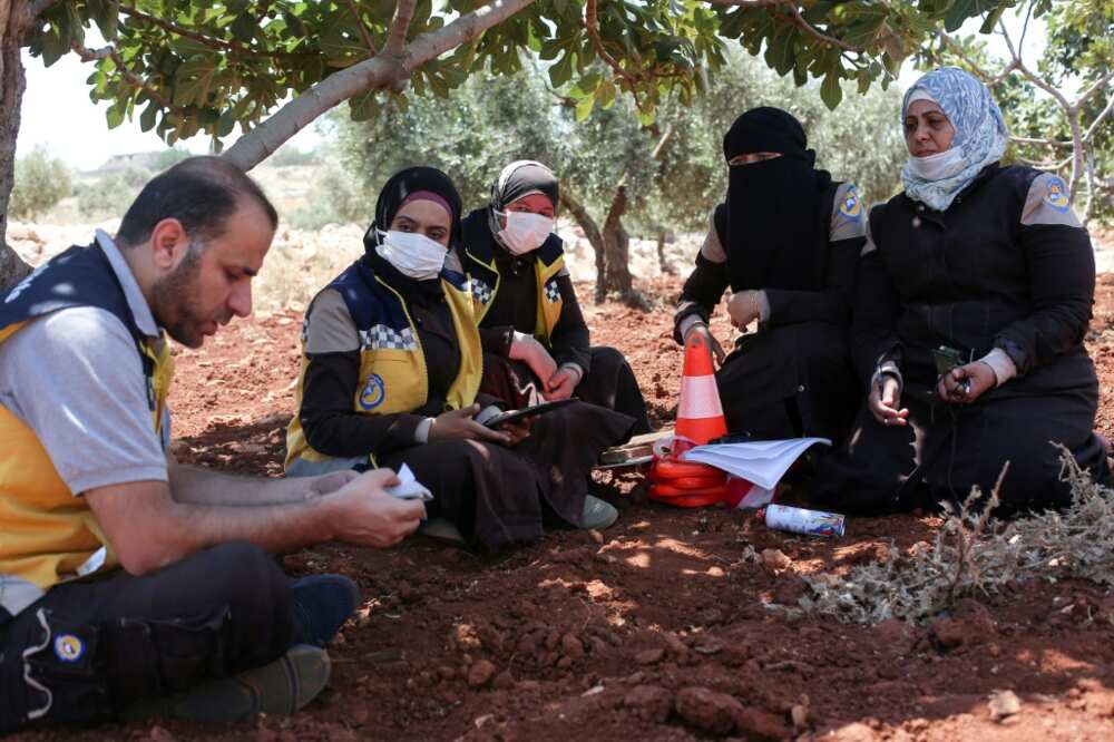 Members of the Syrian civil defence group the White Helmets and volunteers take part in a course on how to locate and neutralise unexploded ordnance