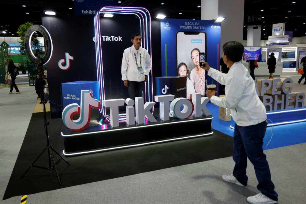 A man poses at the TikTok booth at the international media centre during the Asia-Pacific Economic Cooperation (APEC) summit in Bangkok on November 18, 2022