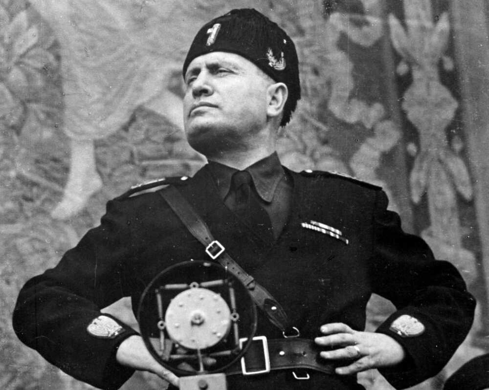 A black and white portrait of Benito Mussolini in a military uniform