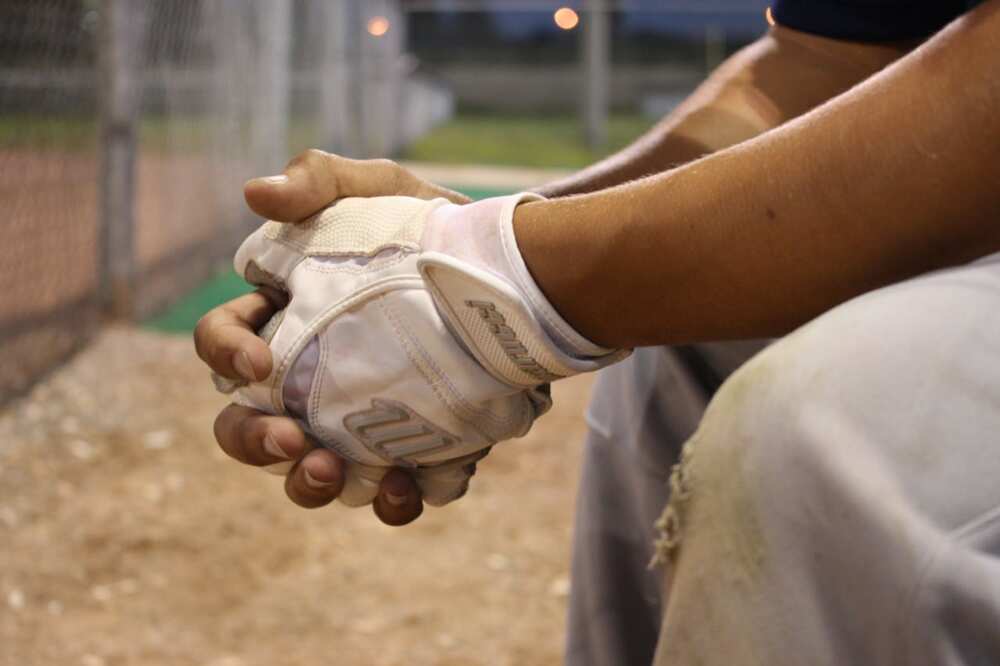 Someone's hands with softball gloves