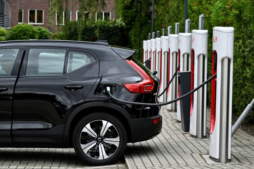 An electric car charges at a charging point reserved for Tesla cars An electric car charges at a charging point reserved for Tesla cars
