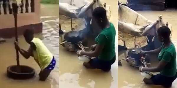 Reactions as Nigerian Ladies are Seen Cooking, Pounding Food Inside Lagos Flood