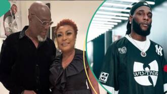 "A whole odogwu": Reactions as Burna Boy's dad gives him brain resetting slap at mum's birthday