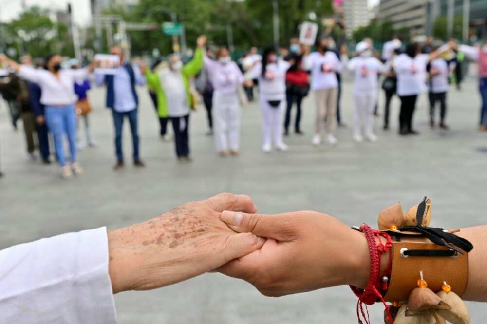 People with missing relatives take part in a pre-Hispanic ritual during a protest against violence, in Mexico City on July 5, 2022