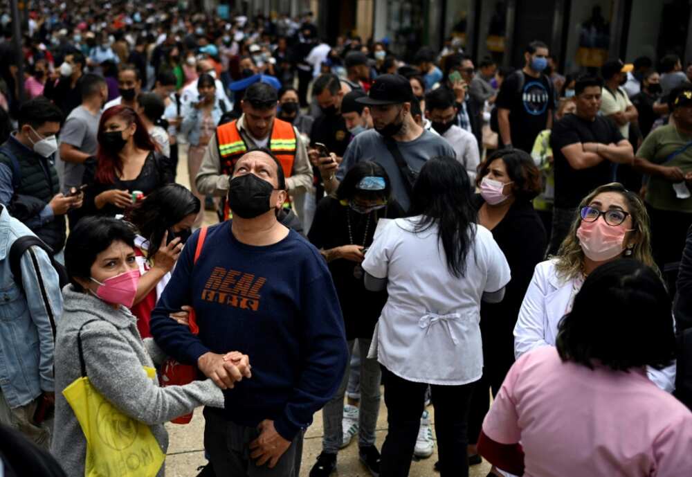 People wait on the streets of Mexico City after a powerful earthquake People wait on the streets of Mexico City after a powerful earthquake