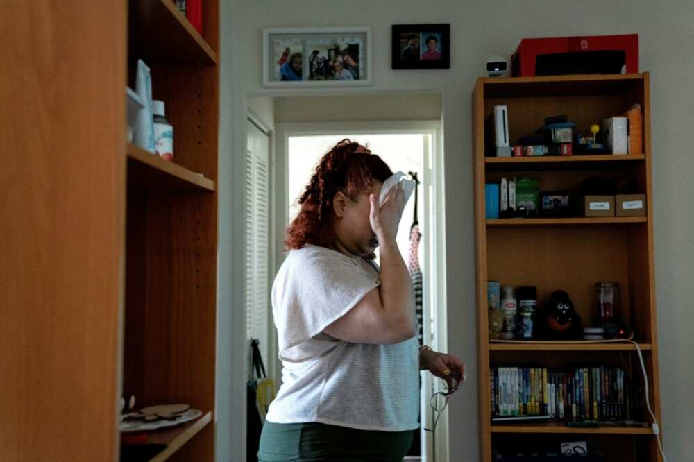 Laine Carolyn, shown here wiping her face during an interview at her Alexandria home, is among tenants in the United States confronting eviction risks in the face of high inflation Laine Carolyn, shown here wiping her face during an interview at her Alexandria home, is among tenants in the United States confronting eviction risks in the face of high inflation