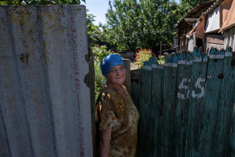 A woman in front of her house in Donbas region, amid Russia's military invasion of Ukraine