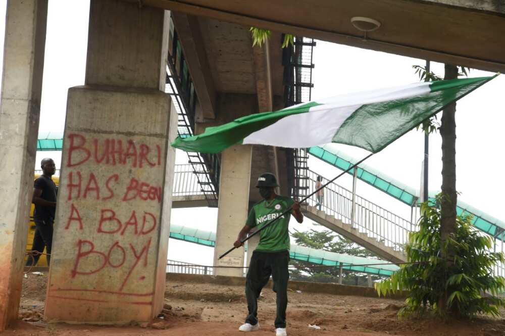 'Flag Boi' Akinwunmi Ibrahim Adebanjo waves Nigeria's colours on the first anniversary of the EndSars protest movement